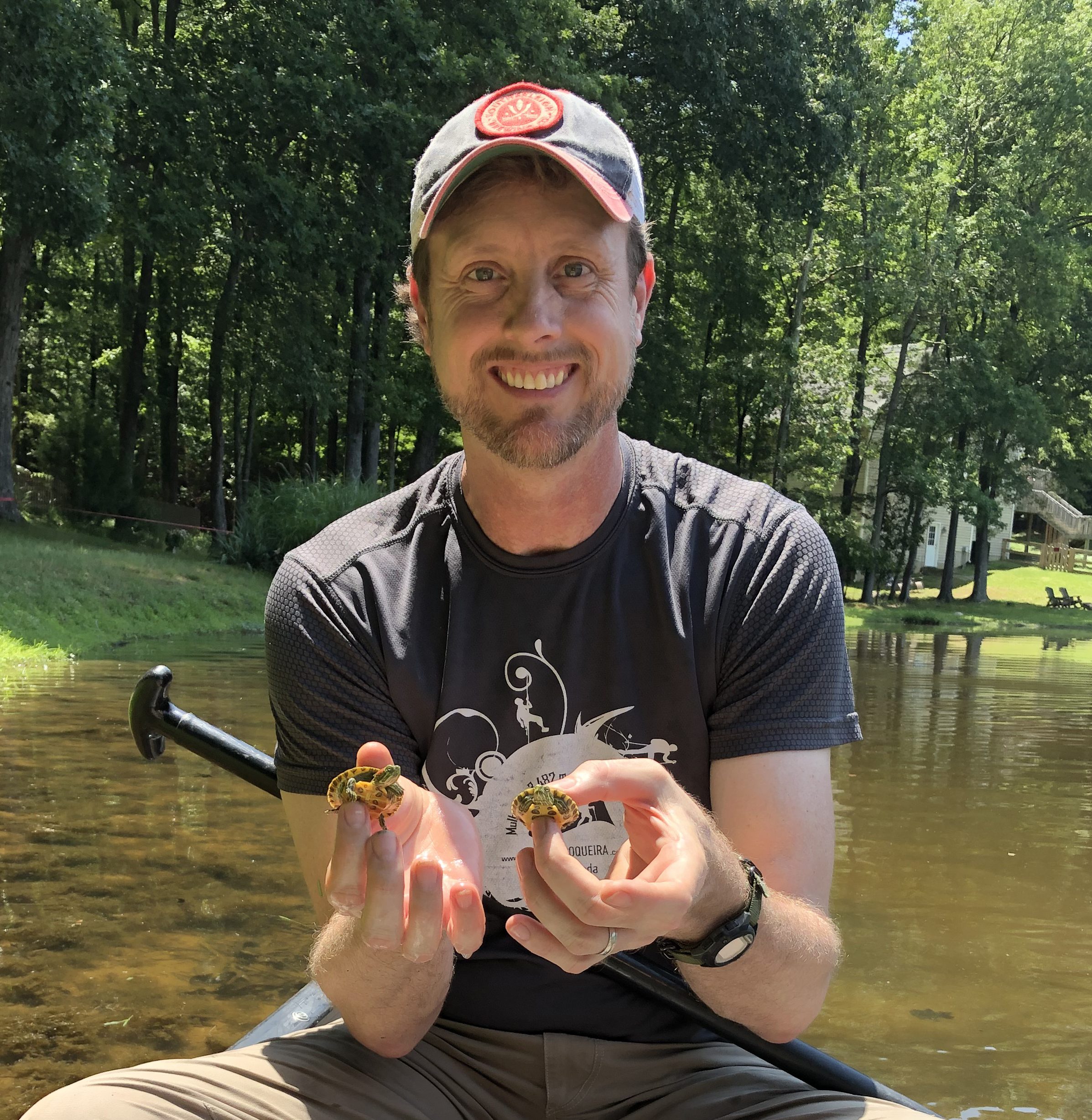 Professor David Salisbury with two small turtles